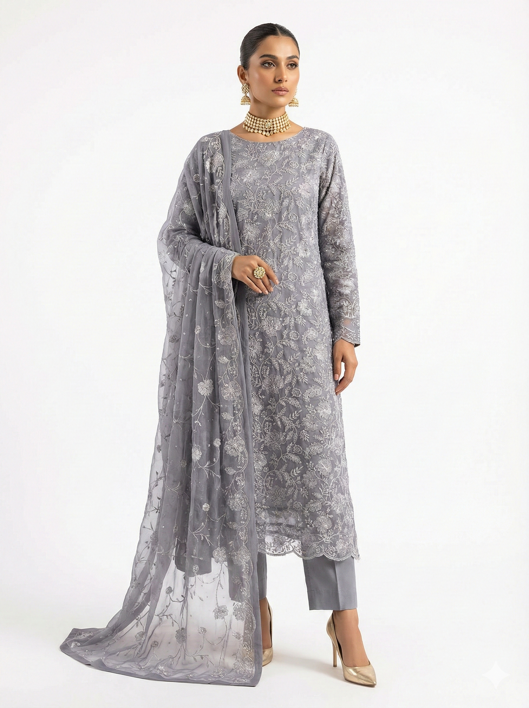 Woman wearing a gray traditional outfit with a matching dupatta on a white background